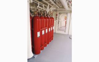 A set of marine high-pressure carbon dioxide fire extinguishers in a marine facility